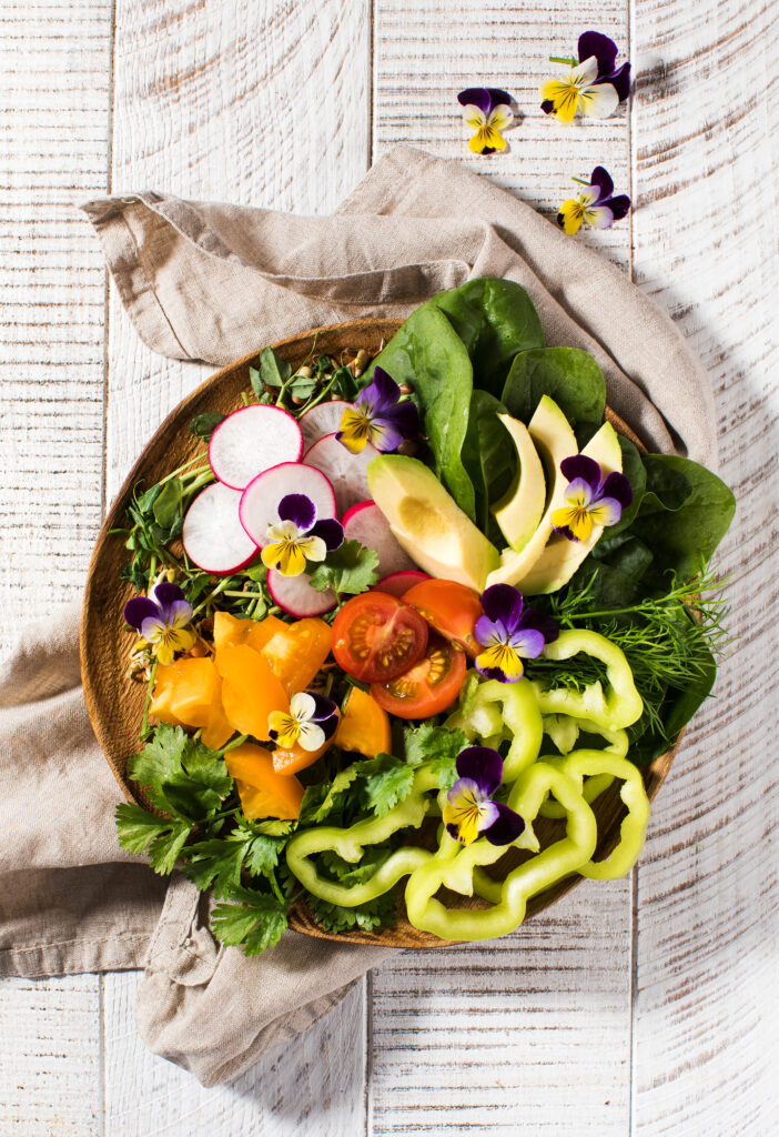 vegetable summer salad decorated with edible flowers. summer dish, summer menu.